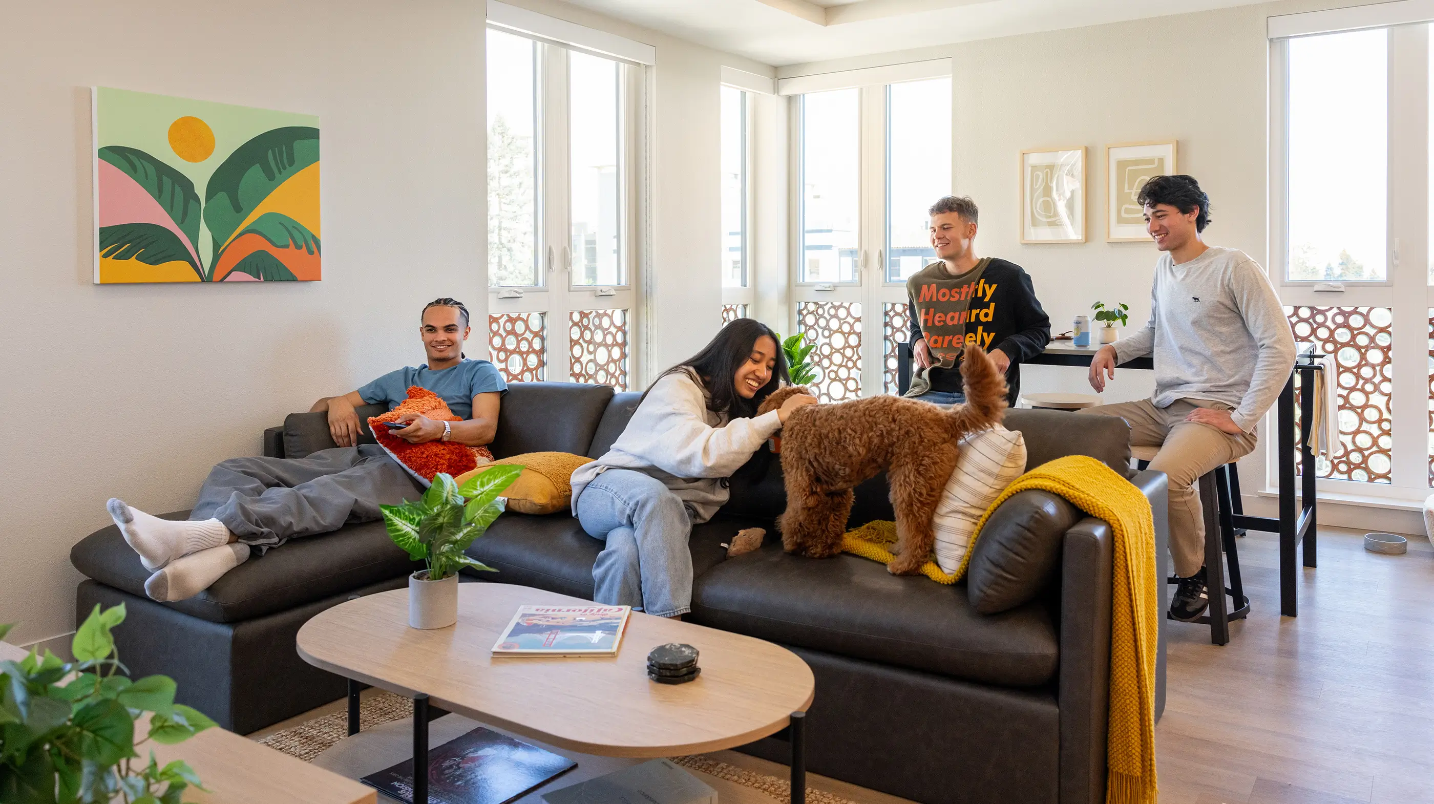 a group of young adults sitting in a living room